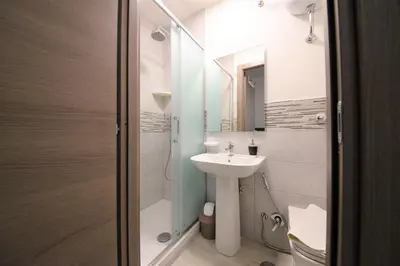 a small bathroom with a sink and a shower at AFFITTACAMERE A CASA MIA in Rome
