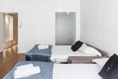 a room with three beds in a room at A World Aparts - 104 Frattina in Rome