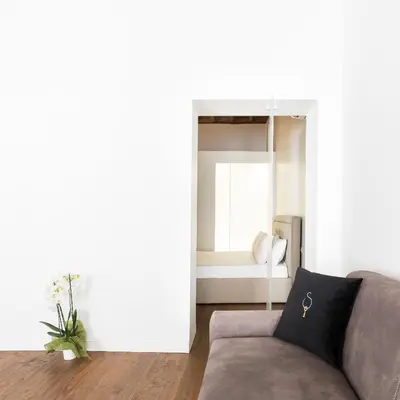 a living room with a couch and a window at A World Aparts - 104 Frattina in Rome