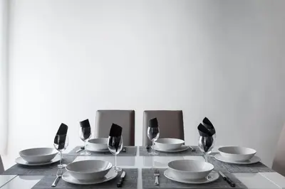 a table with plates and bowls and wine glasses at A World Aparts - 104 Frattina in Rome
