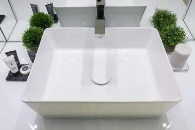 a white sink in a bathroom with plants at A World Aparts - 104 Frattina in Rome