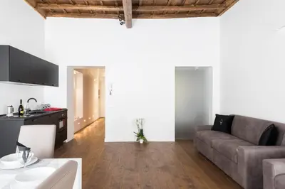 a living room with a couch and a table at A World Aparts - 104 Frattina in Rome