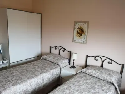 a bedroom with two beds and a mirror at My House in Rome in Rome
