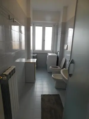 a white bathroom with two toilets and a window at My House in Rome in Rome