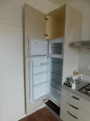 a white refrigerator in a kitchen with its door open at My House in Rome in Rome