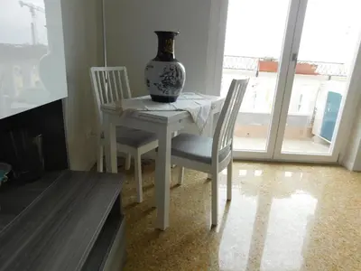 a vase sitting on a table with two chairs at My House in Rome in Rome