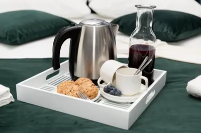 a tray with a coffee maker and a cup of coffee at Unicum Roma Suites in Rome
