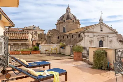 a balcony with a view of a church at Penthouse Rome Capitol in Rome