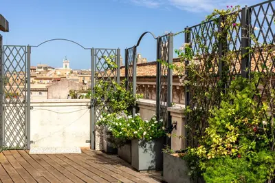 a balcony with plants and flowers on a building at Penthouse Rome Capitol in Rome