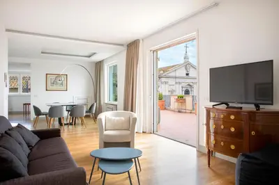 a living room with a couch and a tv and a table at Penthouse Rome Capitol in Rome