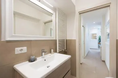 a bathroom with a white sink and a mirror at Lovely New Apartament, Viale Trastevere in Rome