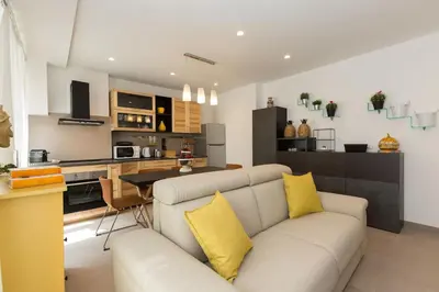 a living room with a couch and a kitchen at Lovely New Apartament, Viale Trastevere in Rome