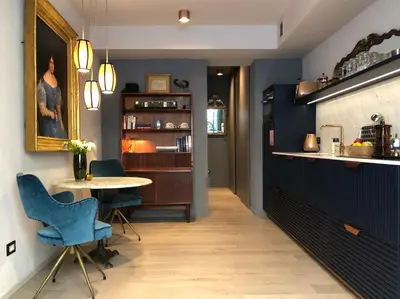 a dining room with blue walls and a table and chairs at Boutique Loft steps from the Colosseum - Gio Roma in Rome