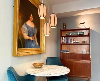 a dining room with a painting of a woman at Boutique Loft steps from the Colosseum - Gio Roma in Rome