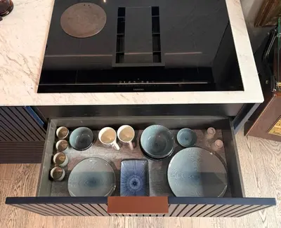 a drawer with bowls and other items in it at Boutique Loft steps from the Colosseum - Gio Roma in Rome
