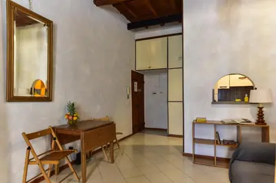 a living room with a table and a chair at Trastevere Queen in Rome