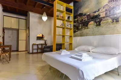 a bedroom with a white bed and a yellow shelf at Trastevere Queen in Rome