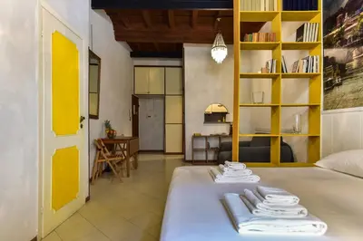 a room with a bed and a living room at Trastevere Queen in Rome