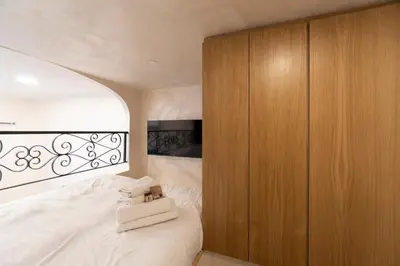 a bedroom with a bed and a wooden cabinet at POPOLO PEN 56 Apartament in Rome
