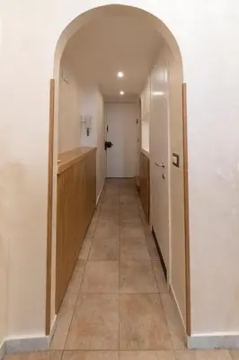 a hallway with an archway leading into a room at POPOLO PEN 56 Apartament in Rome