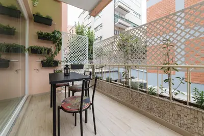 a balcony with a black table and chairs and plants at Appartamenti Clivo di Monte del Gallo in Rome