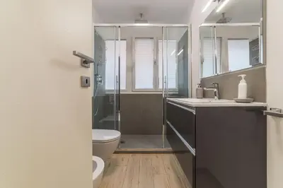 a bathroom with a shower and a toilet and a sink at Appartamenti Clivo di Monte del Gallo in Rome