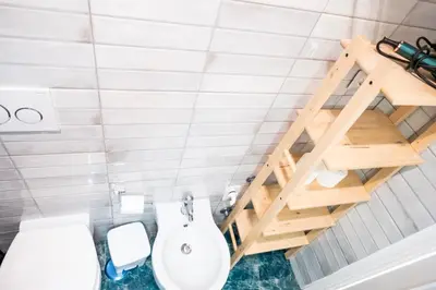 a bathroom with a white toilet and a ladder at Apartment by the Colosseum - White Chic Flats in Rome