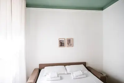 a bedroom with a bed with two pillows on it at Apartment by the Colosseum - White Chic Flats in Rome