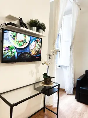 a living room with a tv on a wall at Apartment by the Colosseum - White Chic Flats in Rome