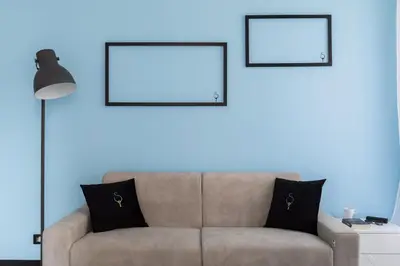a living room with a couch and two pictures on the wall at A World Aparts - 23 Artisti in Rome