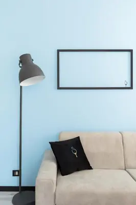 a couch with a black pillow and a lamp at A World Aparts - 23 Artisti in Rome