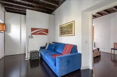 a blue couch sitting in a living room at Delizioso appartamento a Campo de' Fiori in Rome