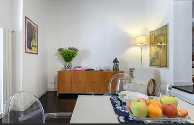 a kitchen with a table with a bowl of fruit on it at Delizioso appartamento a Campo de' Fiori in Rome