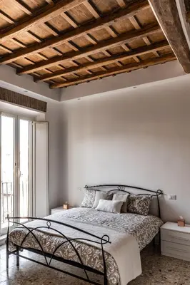 a bedroom with a bed with a wooden ceiling at Campo24roma Guesthouse in Rome