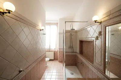 a bathroom with a shower and a toilet at Magna Domus in Rome