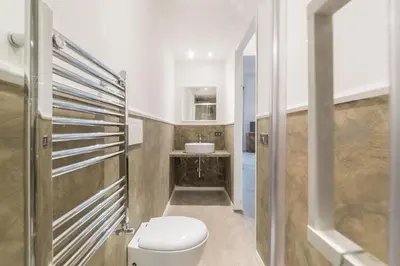 a bathroom with a toilet and a sink at Loft Farnese 1 suite luxury area soggiorno e cucina in Rome