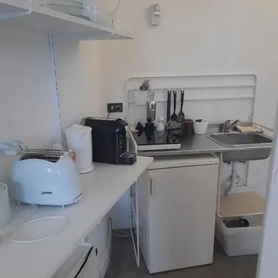 a kitchen counter with a toaster and a sink at Loft Farnese 1 suite luxury area soggiorno e cucina in Rome
