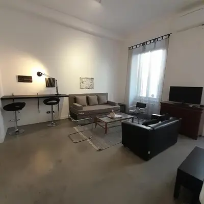 a living room with a couch and a table at Loft Farnese 1 suite luxury area soggiorno e cucina in Rome