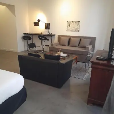 a living room with a couch and a table at Loft Farnese 1 suite luxury area soggiorno e cucina in Rome