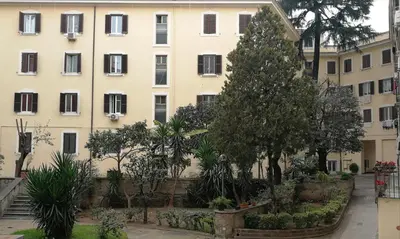 an apartment building with a garden in front of it at Casa di Ele in Rome