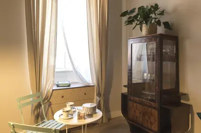 a room with a table and a large window at Casa di Ele in Rome