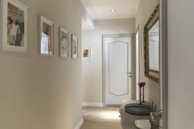a bathroom with a toilet and a mirror at Casa di Ele in Rome