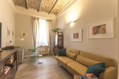 a living room with a couch and a table at Casa di Ele in Rome