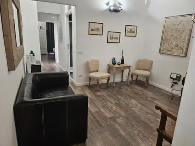 a living room with a black leather couch and chairs at Miriam Apartment in Rome