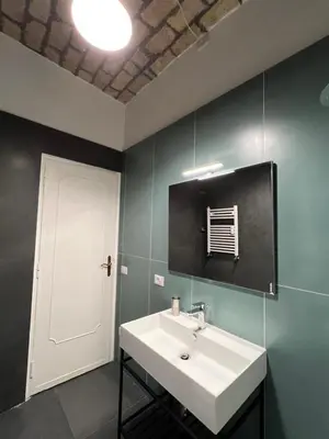 a bathroom with a white sink and a door at Miriam Apartment in Rome