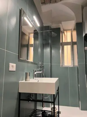 a bathroom with a sink and a mirror at Miriam Apartment in Rome