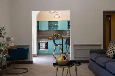 a kitchen counter with a vase of flowers on a sink at Beyond Colosseum in Rome