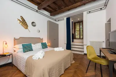 a bedroom with a bed and a television in a room at Beyond Colosseum in Rome