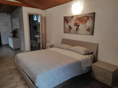 a bedroom with a bed and a painting on the wall at Amazing Appia Antica - Campidoglio in Rome