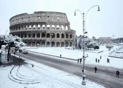 a large building with people walking in the snow at Amazing Appia Antica - Campidoglio in Rome